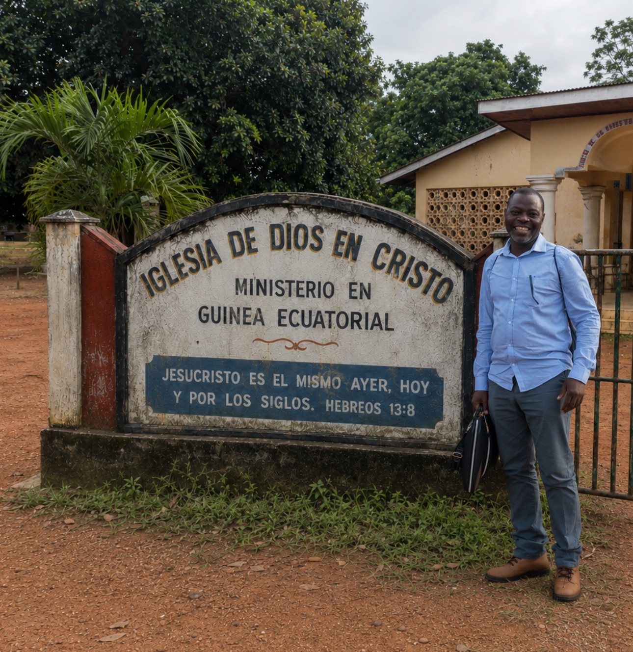 Pastor standing beside an Iglesia de Dios en Cristo sign in Equatorial Guinea.